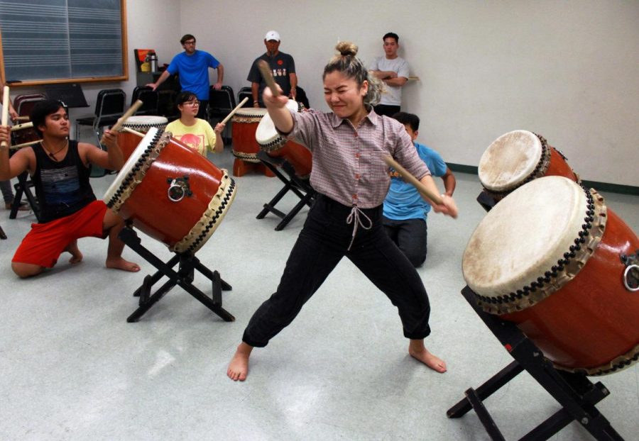 People rehearsing with instruments - taiko drums