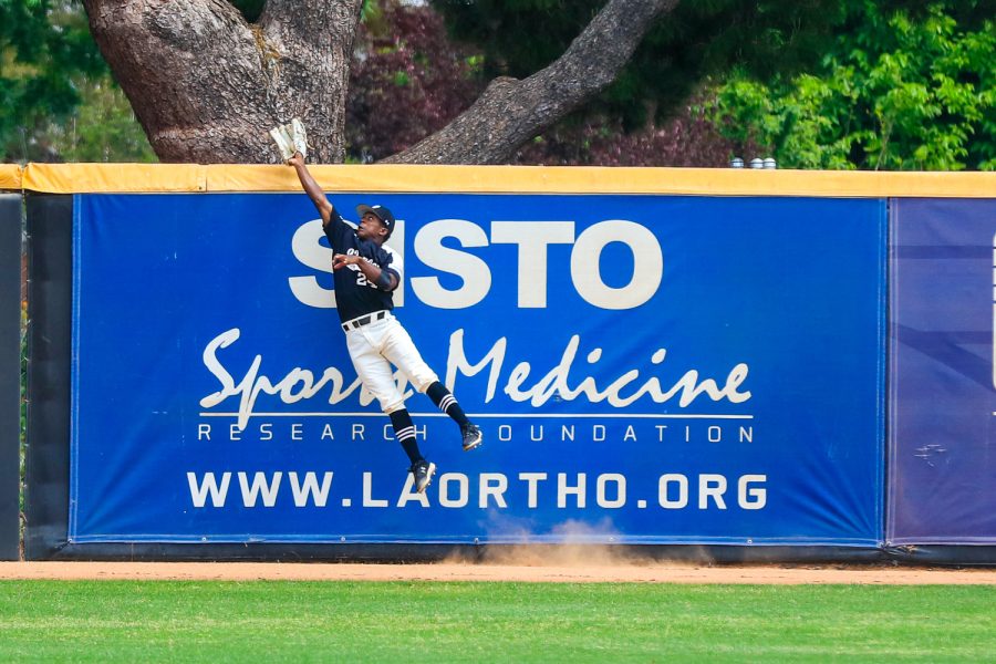 Robert Bullard leaps to catch the ball and prevent a home run during a doubleheader against the Cal State Fullerton Titans in Northrdige, Calif., on Saturday, April 24, 2021. The Matadors lost game one 6-4.