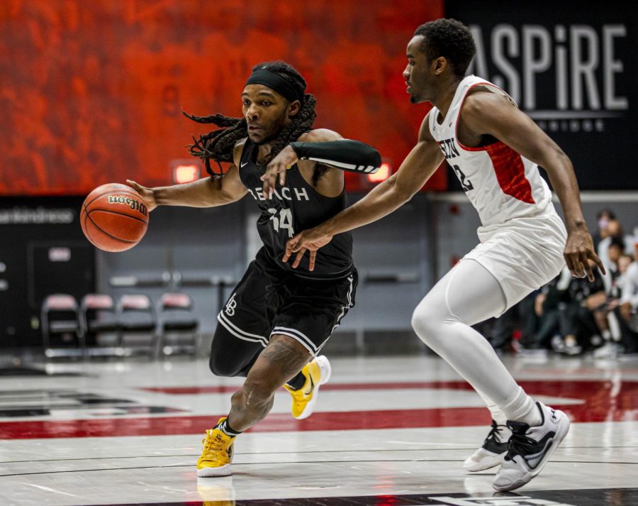 Colin Slater (14) makes a play against Marcel Stevens (12) on the court inside The Matadome during a CSUN home game against Long Beach State. The Beach took the win with a 72-59 victory over CSUN in Northridge, Calif., on Thursday, Feb. 17, 2022.