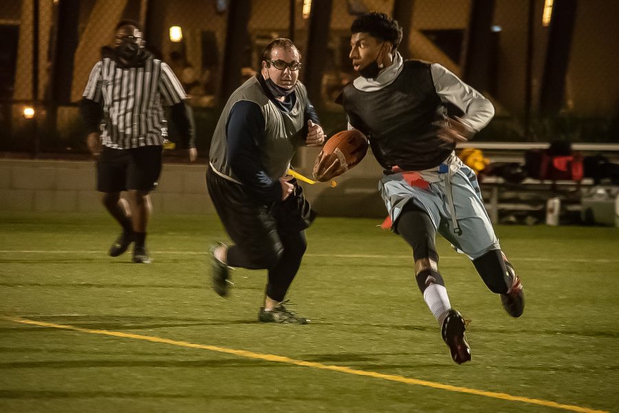 Participants in the CSUN intramural flag football league play on the field behind the Student Recreation Center on Dec. 7, 2021, in Northridge, Calif.