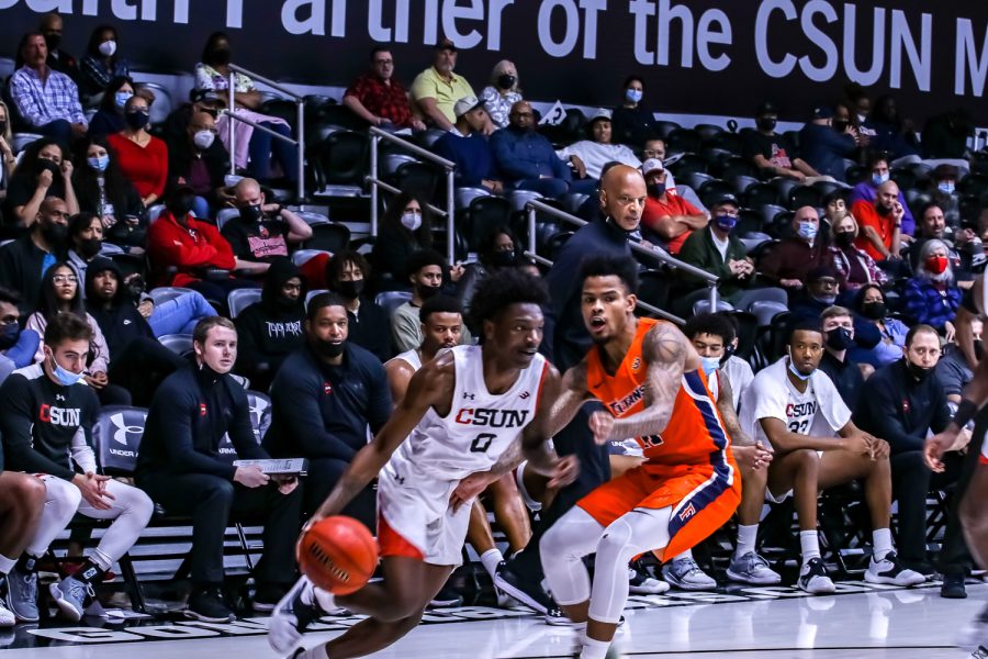 CSUN+guard+Elijah+Hardy+drives+to+the+basket+against+a+Cal+State+Fullerton+defender+on+Feb.19%2C+2022%2C+at+The+Matadome+in+Northridge%2C+Calif.