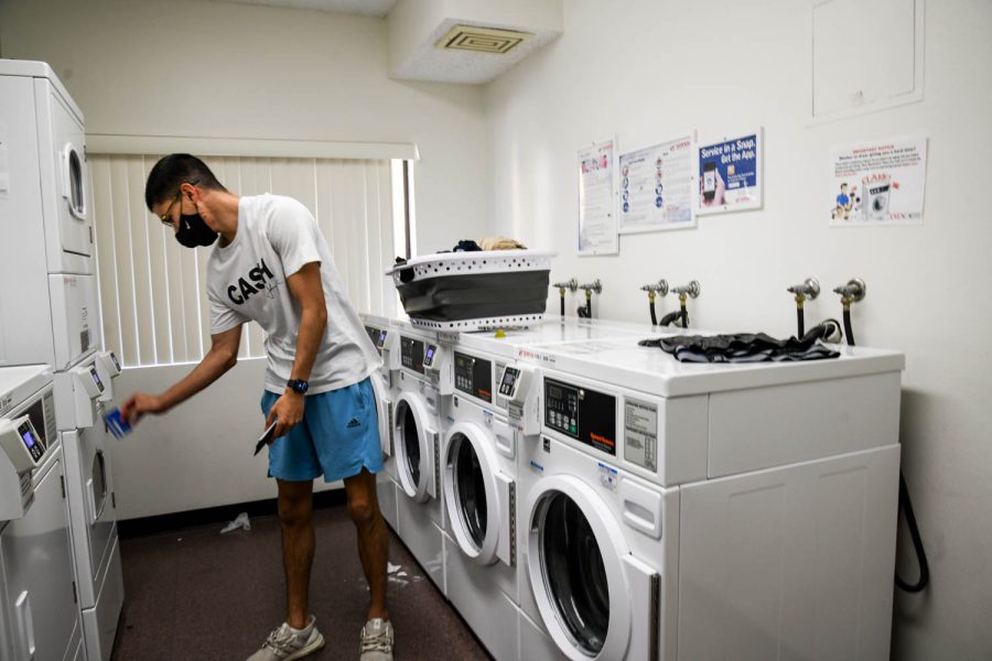 Michael Oh does laundry in the CSUN dorms during Super Bowl Sunday on Feb. 13, 2022, in Northridge, Calif.