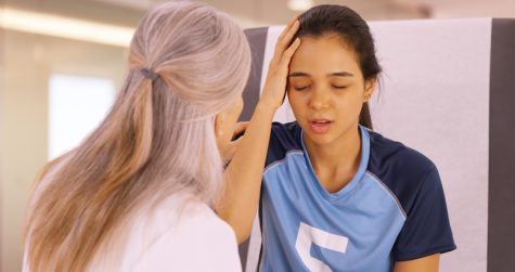A concussed soccer player seeks help from a doctor