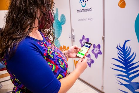 Kayla Kaiser unlocks the lactation pod with an app on her phone on Wednesday, April 20, 2022, in Northridge, Calif.
