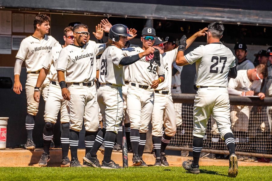 Mason Le returns to the dugout to be greeted by his team as they take on Long Beach State on March 27, 2022, at Matador Field in Northridge, Calif. Photo courtesy of Cal State Long Beach Athletics.