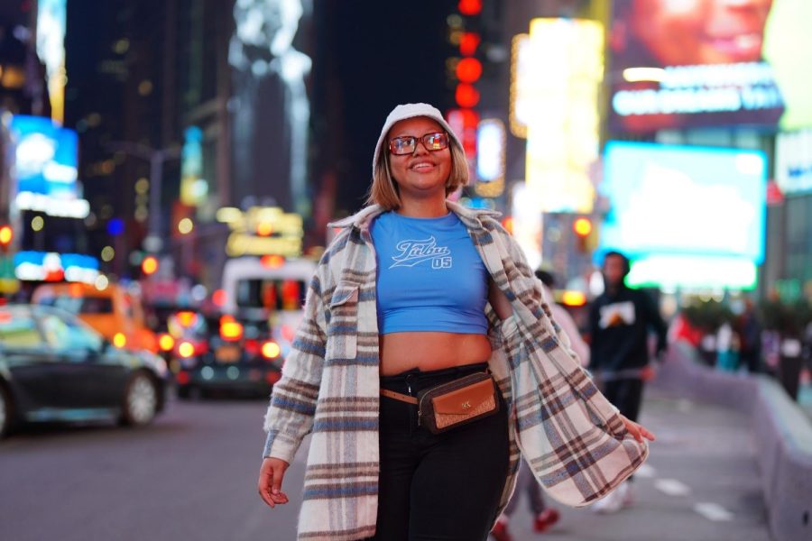 A woman posing for a picture at the times square