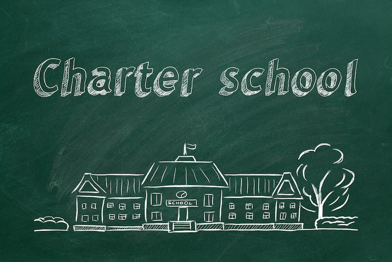 School building and lettering Charter school on blackboard. Hand drawn sketch.