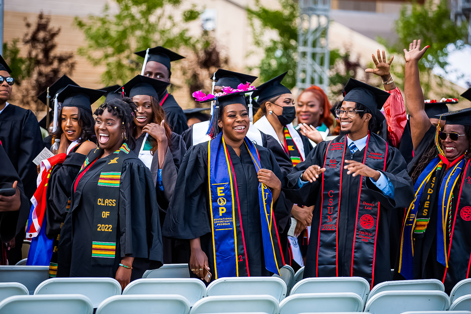 Graduates of the class of 2021-2022 smile at the friends and family in attendance during the 50th celebration of Black Graduation on May 15, 2022, in front of the University Library in Northridge, Calif.