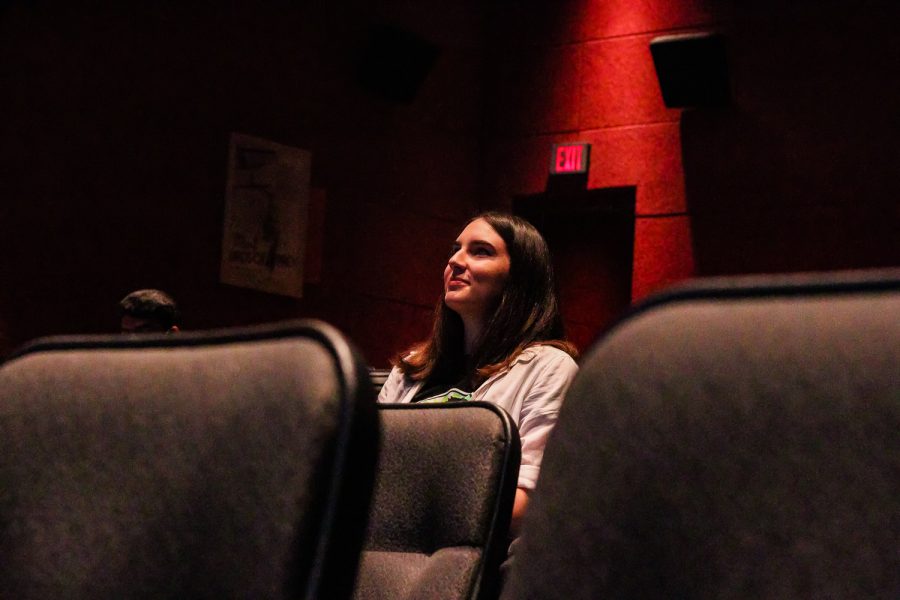 A woman in a movie theater room