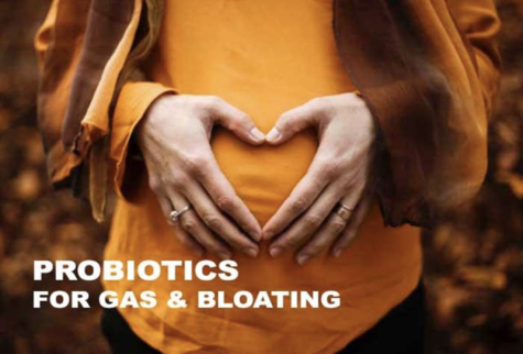 A woman with her hand on her stomach and a quote probiotics for gas & bloating