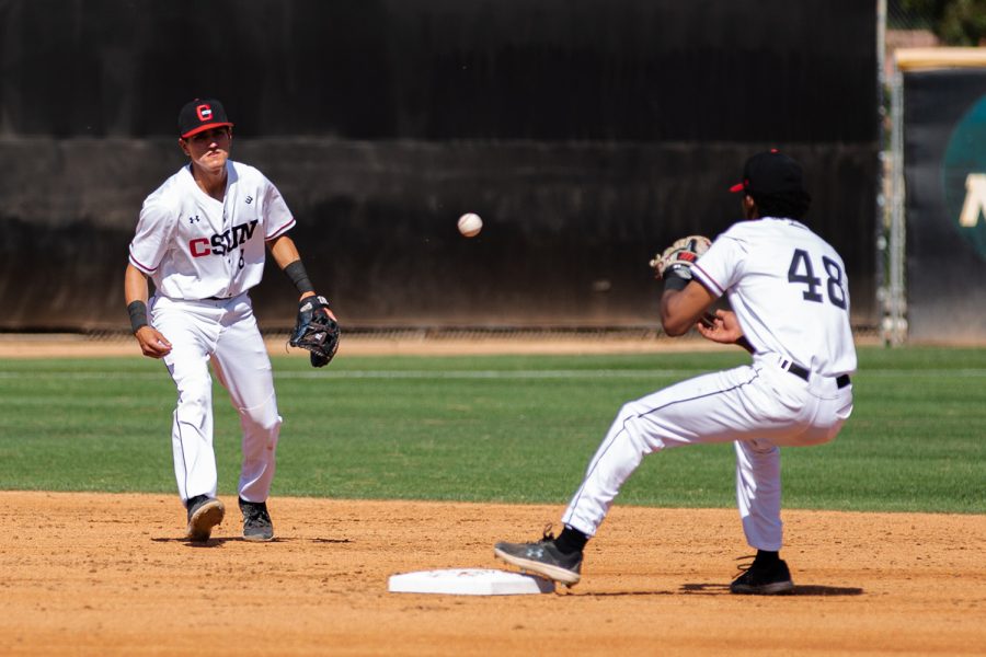 Kai Moody and Brandon Bohning turning a double play on April 8, 2022, in Northridge, Calif.