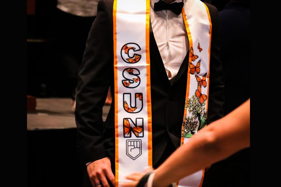 Graduating student displaying their sash at the Undocu-Graduation ceremony at CSUN on Saturday, May 7, 2022, in Northridge, Calif.