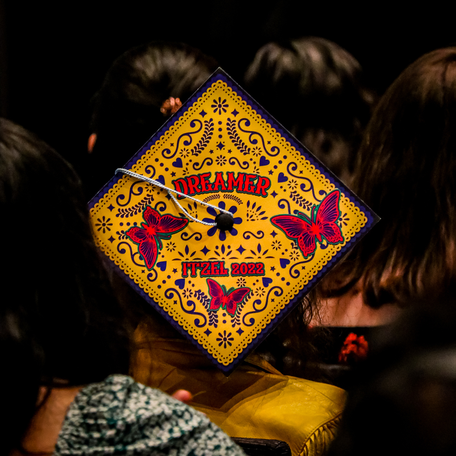 A student showing off their decorated graduation cap at the Undocu-Graduation ceremony on Saturday, May 7, 2022, in Northridge, Calif.