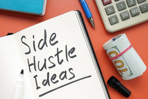 Side hustle ideas list and cash on the desk.