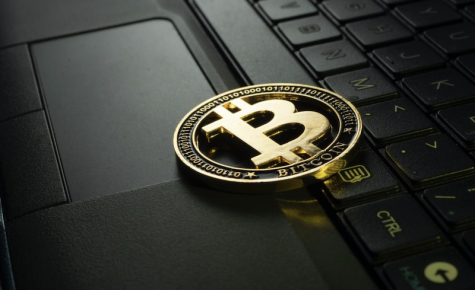 Gold Bitcoin on back laptop keyboard