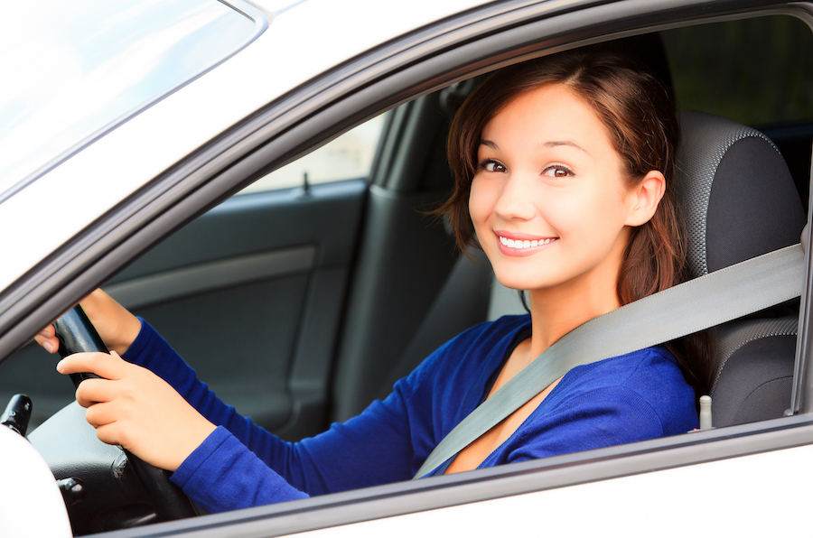 Smiling female driver in a bright blue top