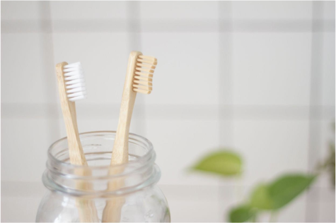 bamboo toothbrushes in a clear glass jar