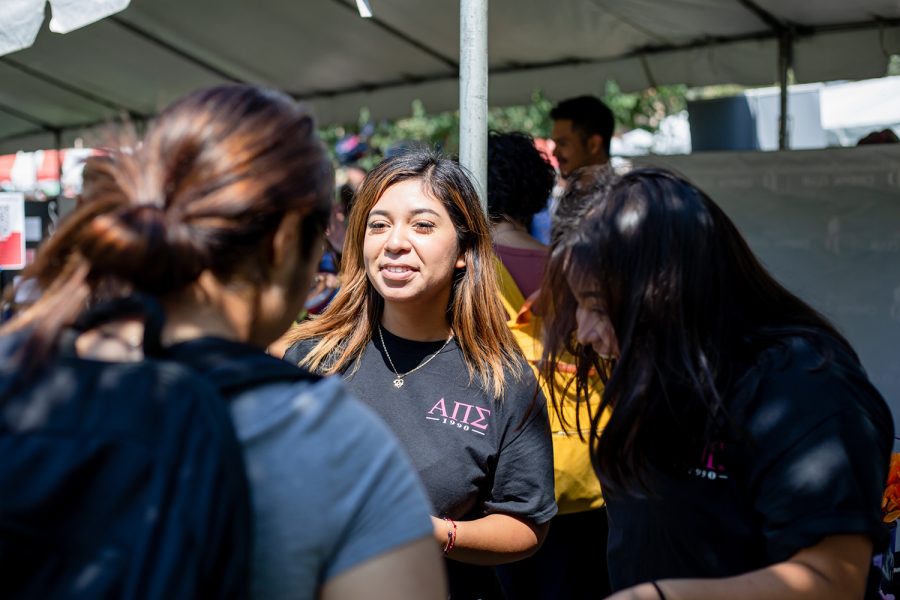 Claudia Flores, a member of Alpha Pi Sigma sorority, discusses the sorority with potential recruits in Northridge, Calif., on Sept. 13, 2022.
