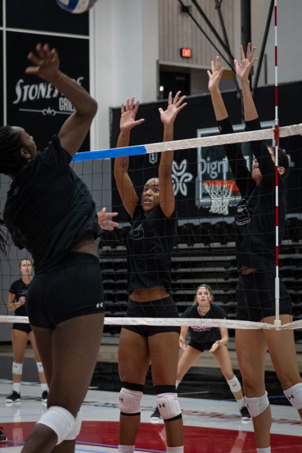 Lauryn Anderson jumps up to block her teammates hit during practice in the Premier America Credit Union Arena in Northridge, Calif., on Wednesday, Sept. 14, 2022.