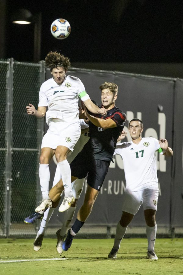 Defender Conner Leber, left, from Cal Poly San Luis Obispo heads the ball away from from CSUN forward Levin Gerhardt, center, on the Performance Soccer Field on Wednesday, Oct. 12, 2022, in Northridge, Calif.