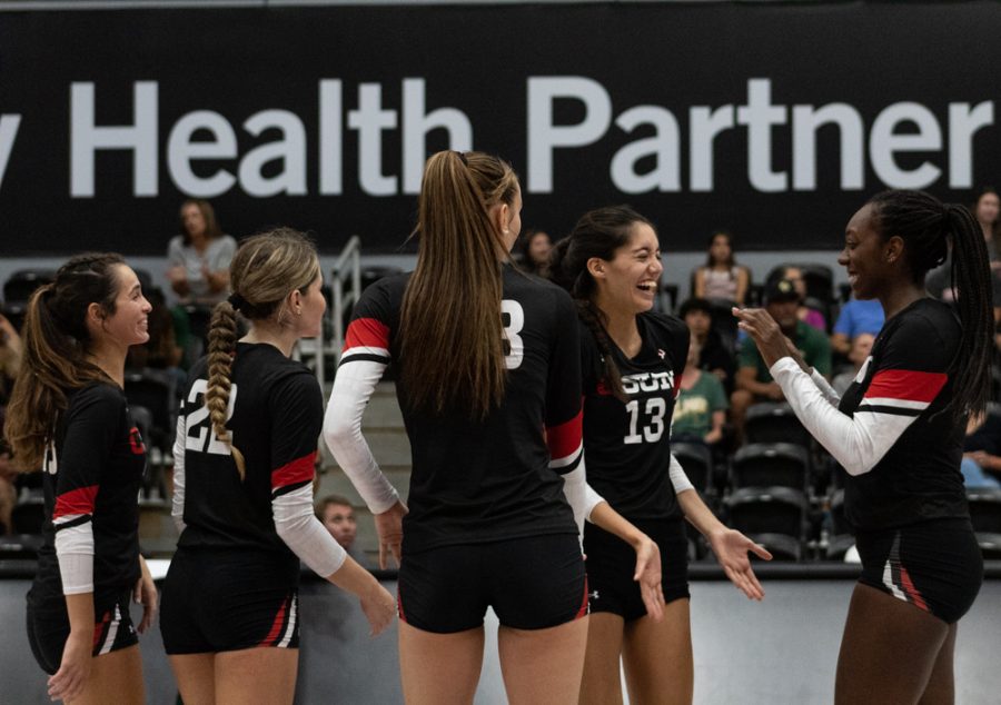 The Matadors womens volleyball team high-fives each other to celebrate scoring against Cal Poly San Luis Obispo on Oct. 1, 2022, at the Premier America Credit Union Arena in Northridge, Calif.