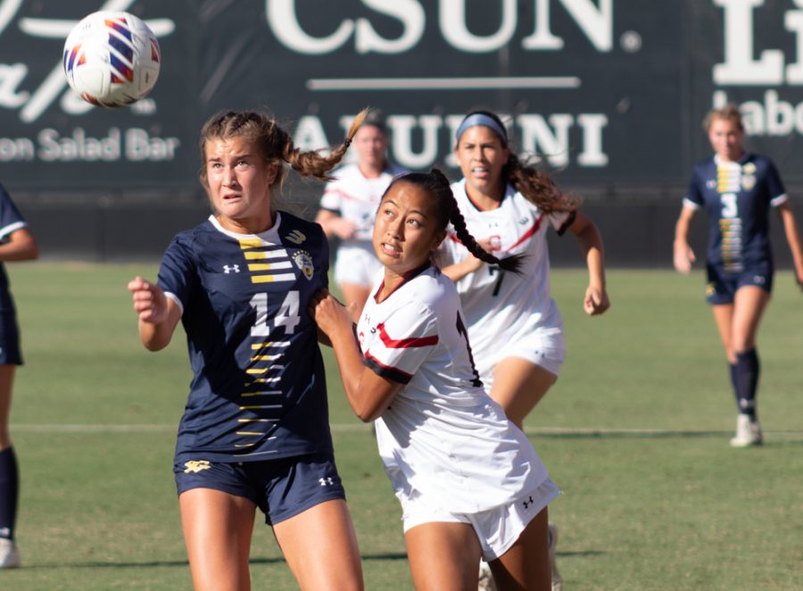 CSUN forward Cassidy Imperial-Pham, center, fights to get the ball against UC San Diego defender Talisa Lin, 14, on Sunday, Oct. 23, 2022, at the Performance Soccer Field in Northridge, Calif.