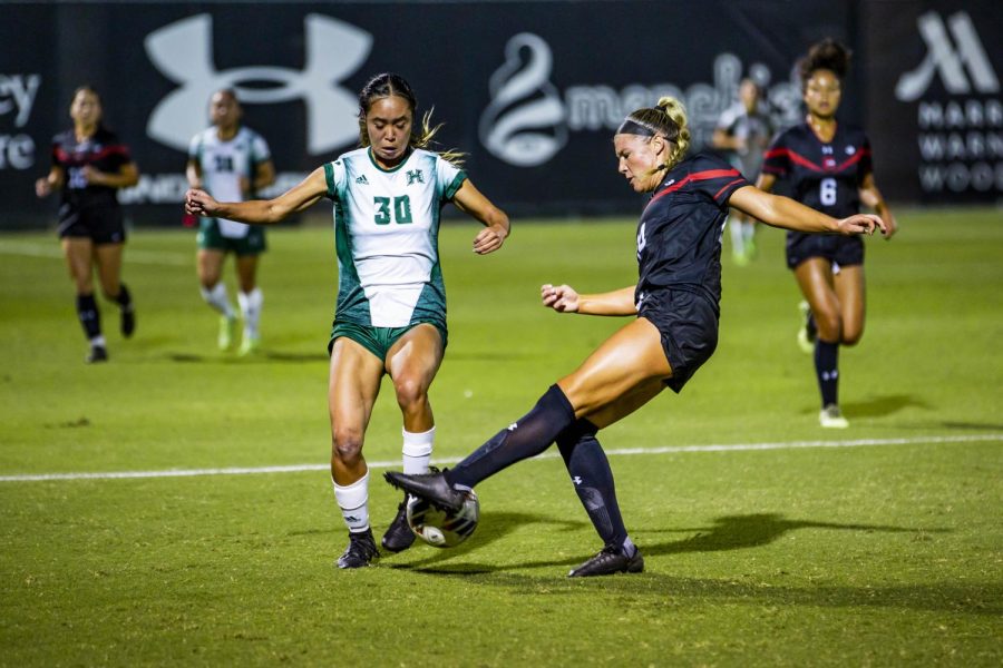 Hawaii forward Kelci Sumida, 30, goes for the ball as Matadors defender Kacie Garrity, 24, moves to steal it, in a game at the Matador Soccer Field on Thursday, Oct. 6, 2022, in Northridge, Calif.