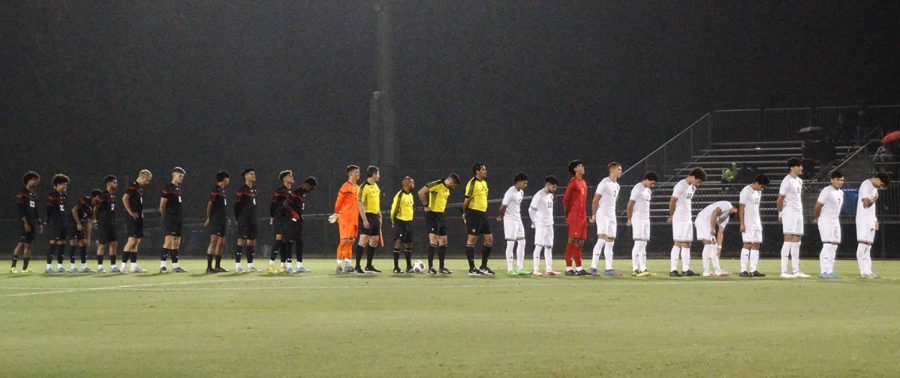 CSUN and UC Irvine stand in formation during the national anthem ceremony on Saturday, Oct. 22, 2022, at the Performance Soccer Field in Northridge, Calif.