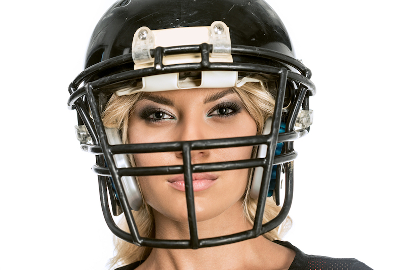 blonde woman wearing black football helmet