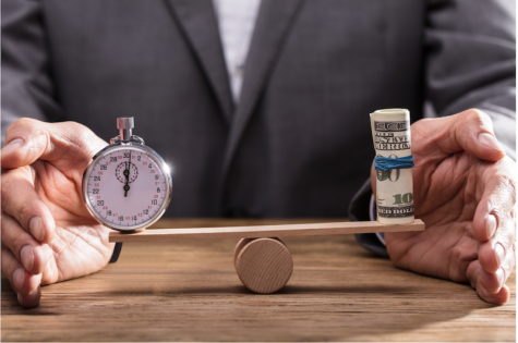 man in suit balancing stopwatch and roll of money