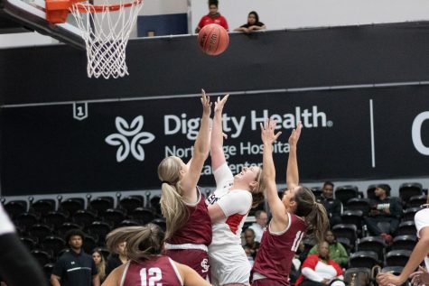 CSUN forward Tess Amundsen, 15, goes up for a rebound against defenders from the Santa Clara University Broncos on Thursday, Nov. 17, 2022, at the Premier America Credit Union Arena in Northridge, Calif.