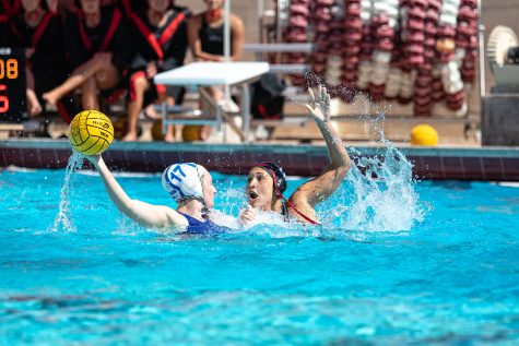 Womens Water polo playing in the water against another team