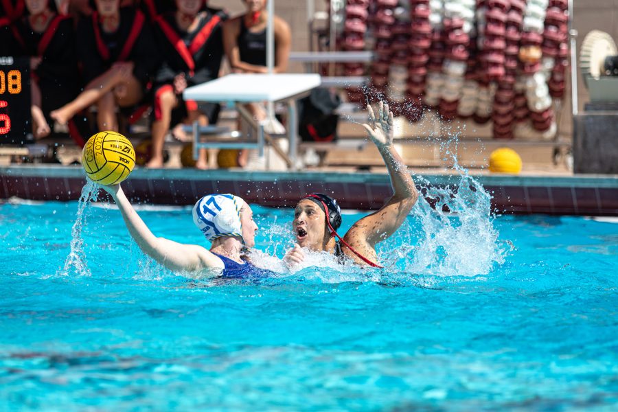 Womens Water polo playing in the water against another team