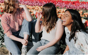 Three laughing women in a field of tulips
