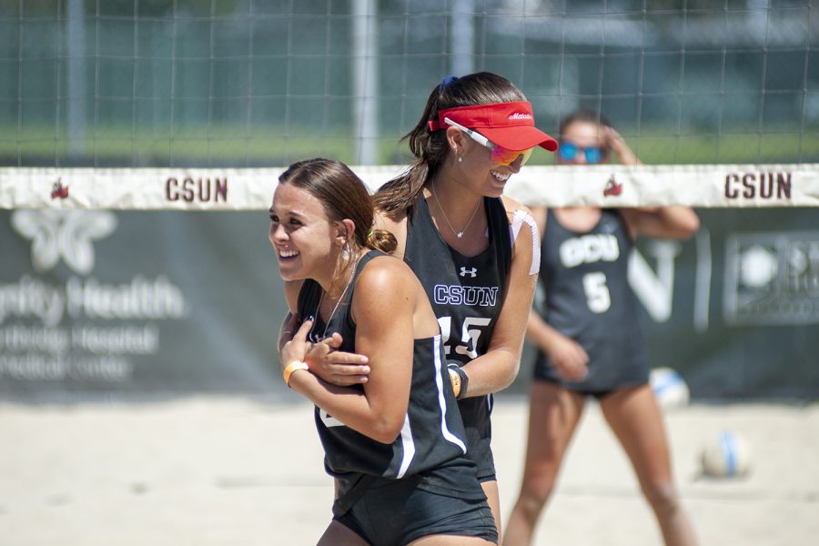 Two CSUN female beach volleyball player celebrating
