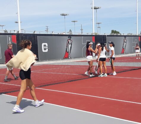Jolene Coetzee, right, and Angela Ho, middle, shake hands with their opponents from Fordham after defeating them 7-5, as Yuliia Zhytelna, left, cheers from the sidelines on Saturday, March 18, 2023, at the Matador Tennis Complex in Northridge, Calif.