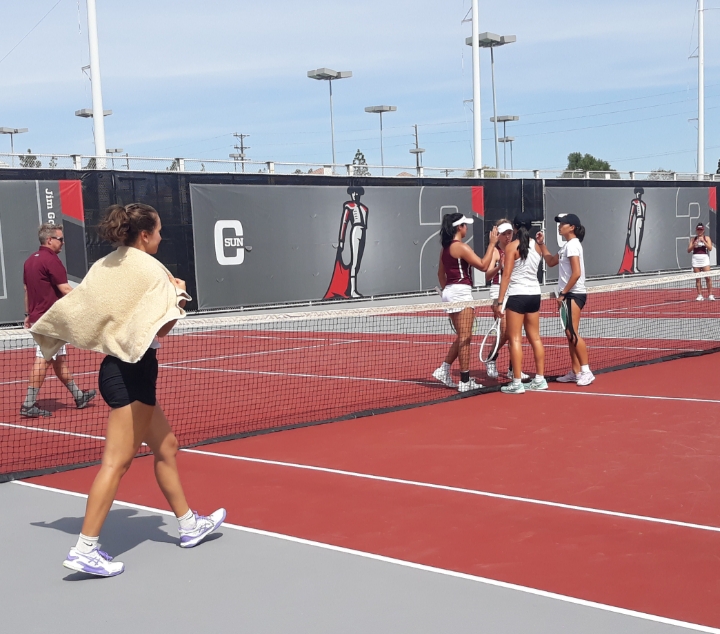 CSUN womens tennis team shaking hands with their opponents