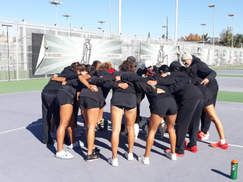 CSUN womens tennis team huddle each other