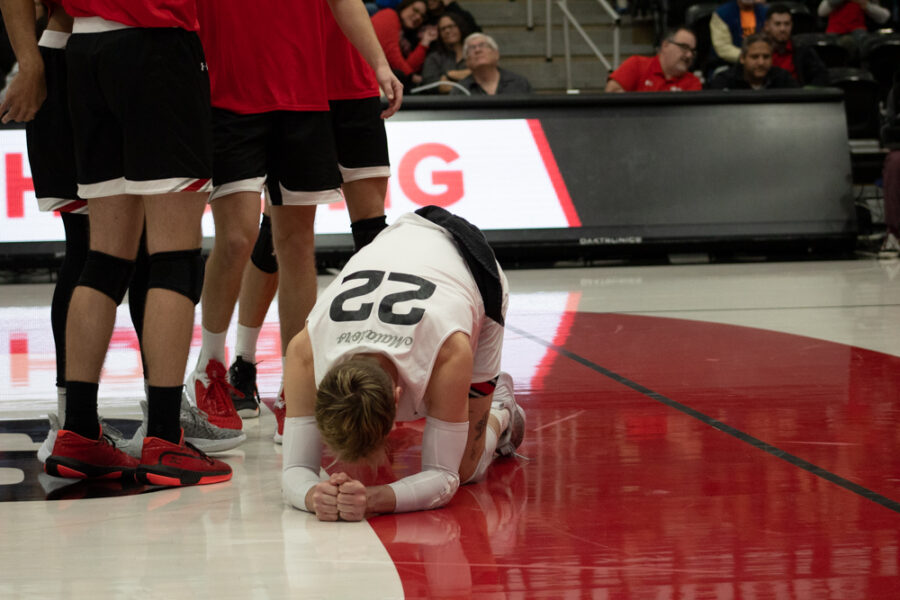 CSUN volleyball player on the floor after dive for the ball