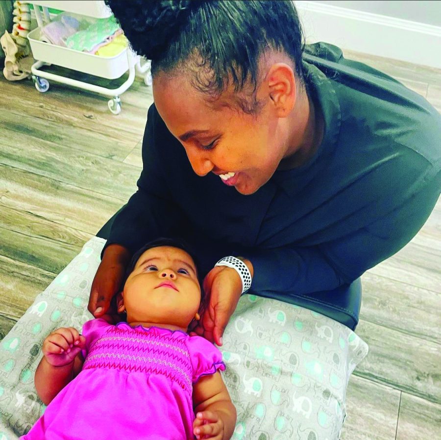 Martha Mekonen works with a pediatric patient at her practice.