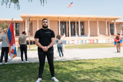 CSUN Armenian Students Association President Varuzhan Bilbulyan stands in front of the CSUN University Library during the Stain of Denial protest on April 25, 2023, in Northridge, Calif.