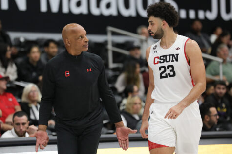 CSUN mens basketball player talking with his coach