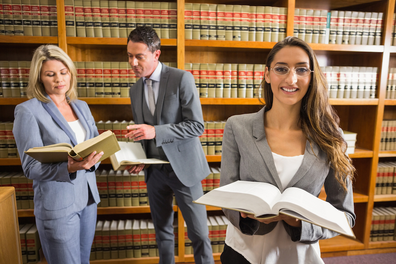 Female and male lawyers in a law library