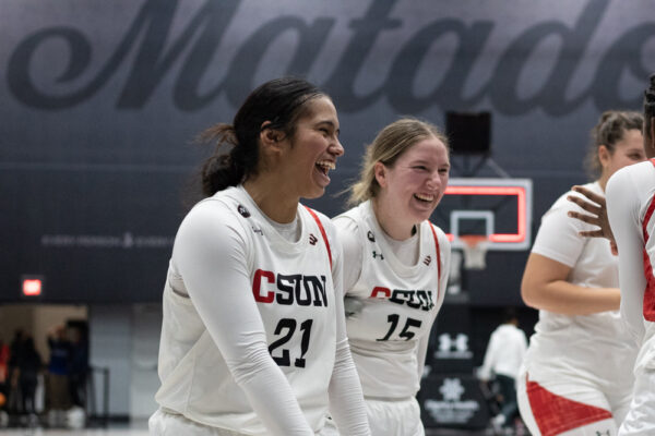 Guard Anaiyah Tuua, 21, and forward Tess Amundsen, 15, laugh and smile with teammates as they head to the locker room after beating CSU Bakersfield on Thursday, Feb. 9, 2023, at the Premier America Credit Union Arena in Northridge, Calif.