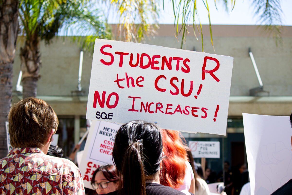 A+student+holds+up+a+sign+during+a+rally+outside+of+the+CSU+Board+of+Trustees+meeting+in+Long+Beach%2C+Calif.%2C+on+Sept.+12%2C+2023.