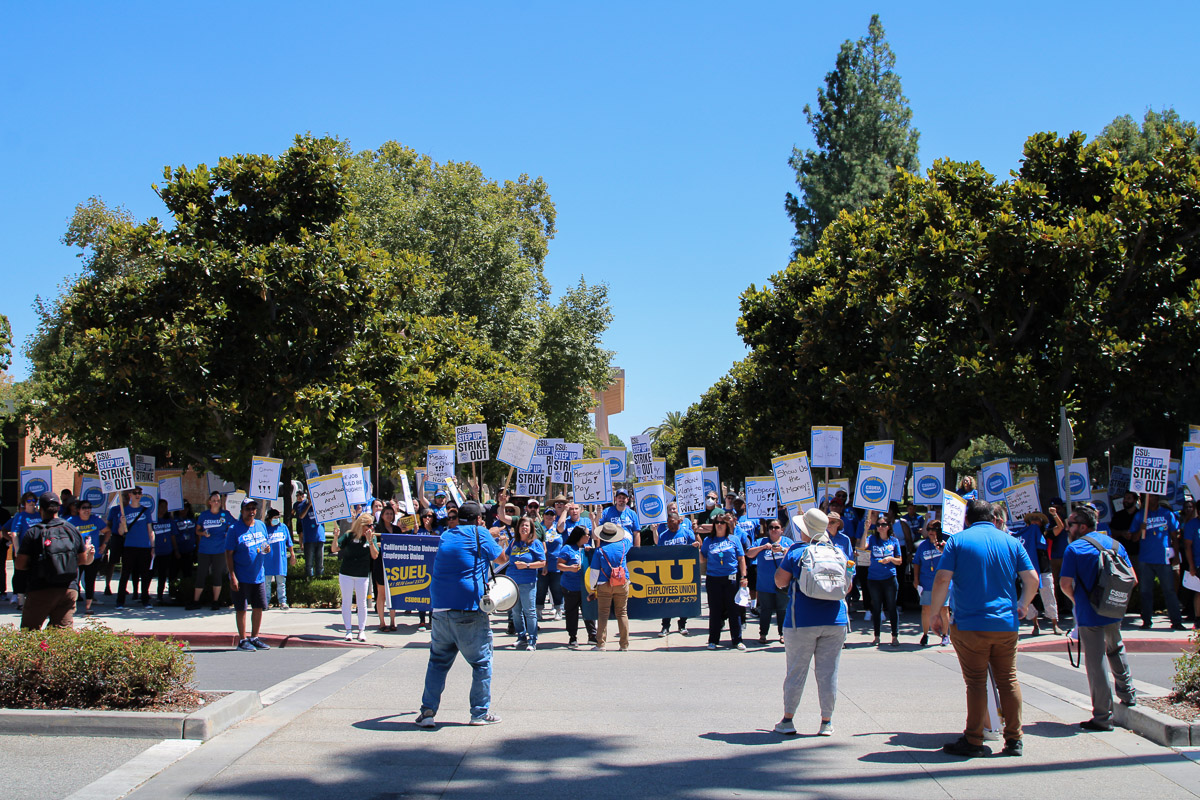 Protestors yelling chants outside of Valera Hall during the California State University strike, holding up signs at CSUN on Sept. 5 in Northridge, Calif.