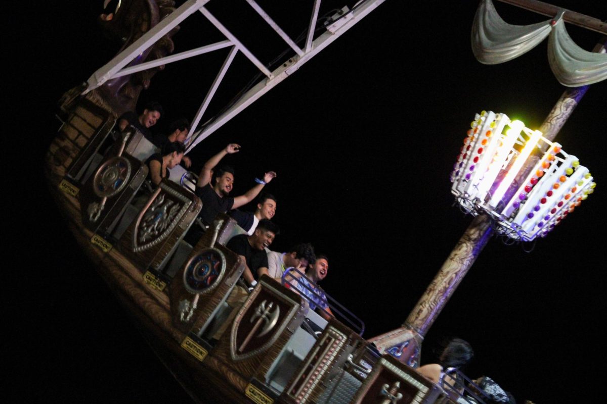 Students scream as the "Sea Dragon" boat ride catches momentum and sends its riders into the air on Sept. 8, 2023, in Northridge, Calif. The ride saw a non-stop line lasting until midnight.