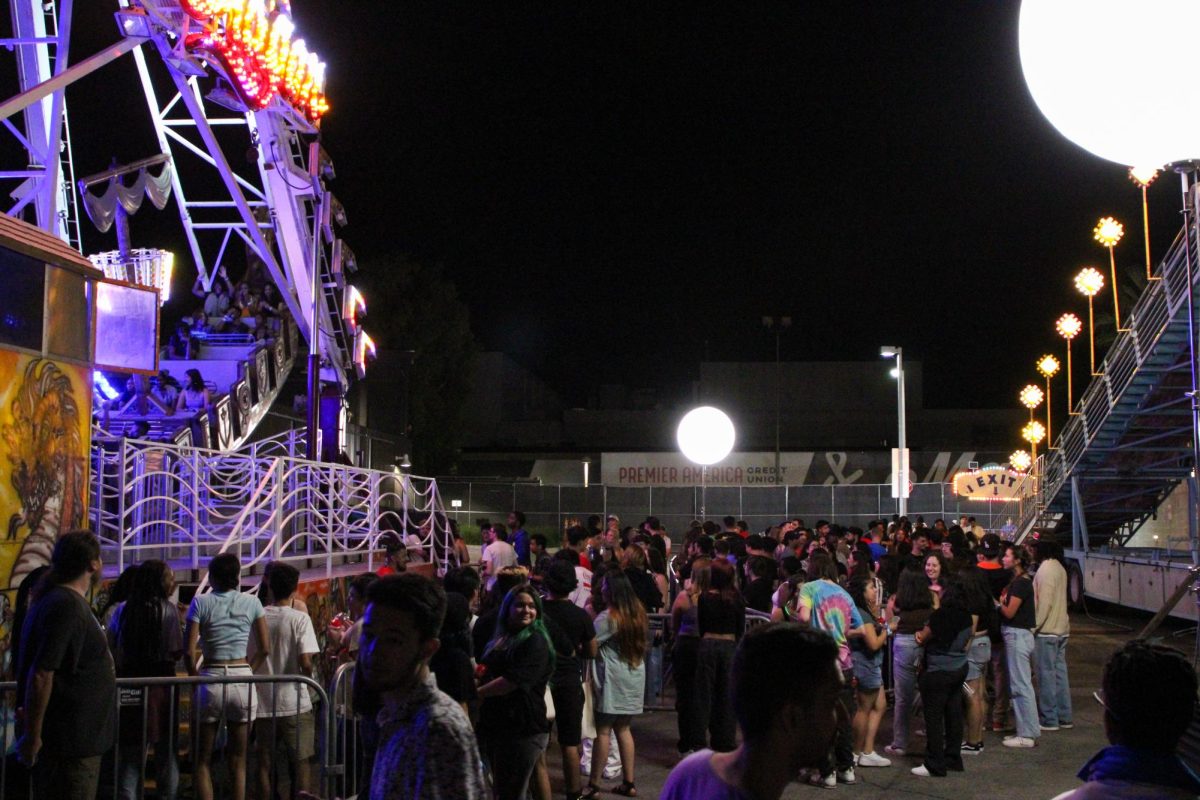 Students line up for carnival rides on Friday, Sept. 8, 2023, in Northridge, Calif. The Sea Dragon boat ride and slides were open for students throughout the nights festivities.