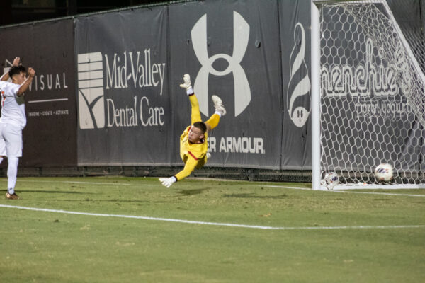 Goalkeeper Cooper Wenzel, 1, dives to try to block the ball during the game against CSU Fullerton at Matador Soccer Field in Northridge, Calif., on Sept. 27, 2023.