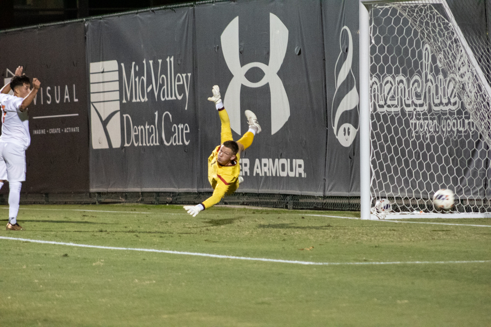Goalkeeper+Cooper+Wenzel%2C+1%2C+dives+to+try+to+block+the+ball+during+the+game+against+CSU+Fullerton+at+Matador+Soccer+Field+in+Northridge%2C+Calif.%2C+on+Sept.+27%2C+2023.